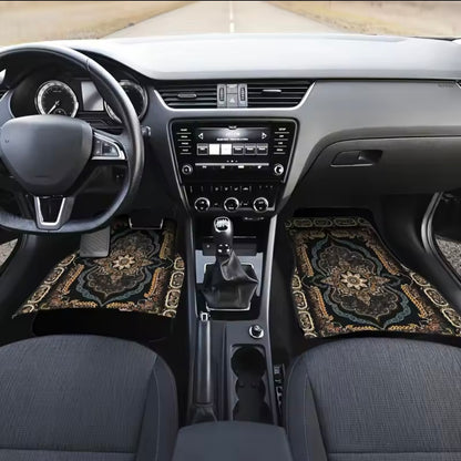 Car interior with decorative floor mats on the driver and passenger sides.