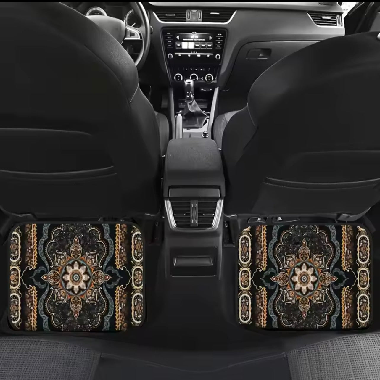 Car interior with decorative floor mats featuring intricate patterns.