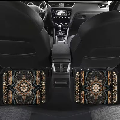 Car interior with decorative floor mats featuring intricate patterns.