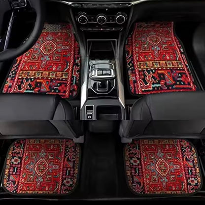 Car interior with patterned red and black floor mats on a black car floor.